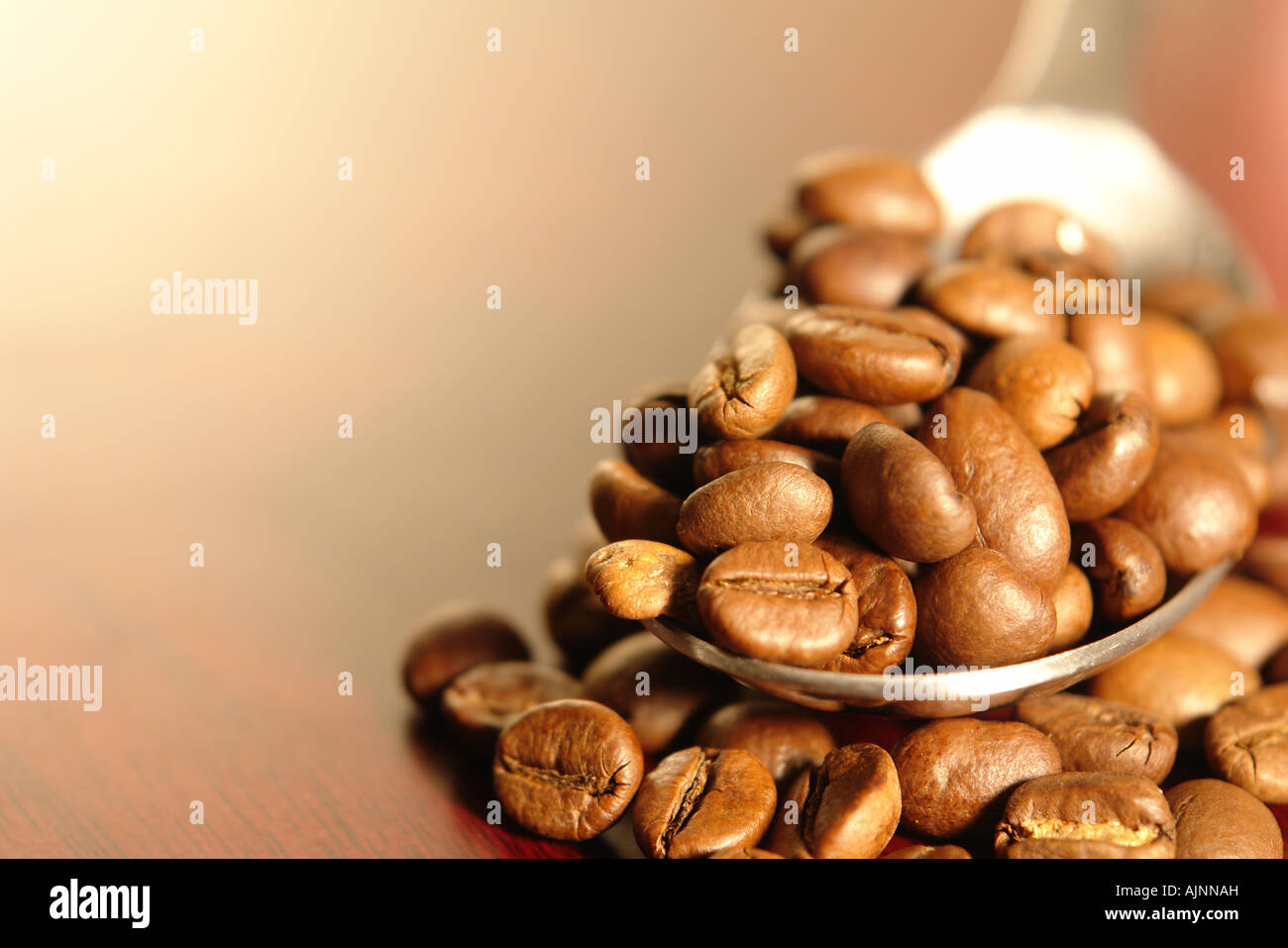 Coffee beans in a spoon Stock Photo