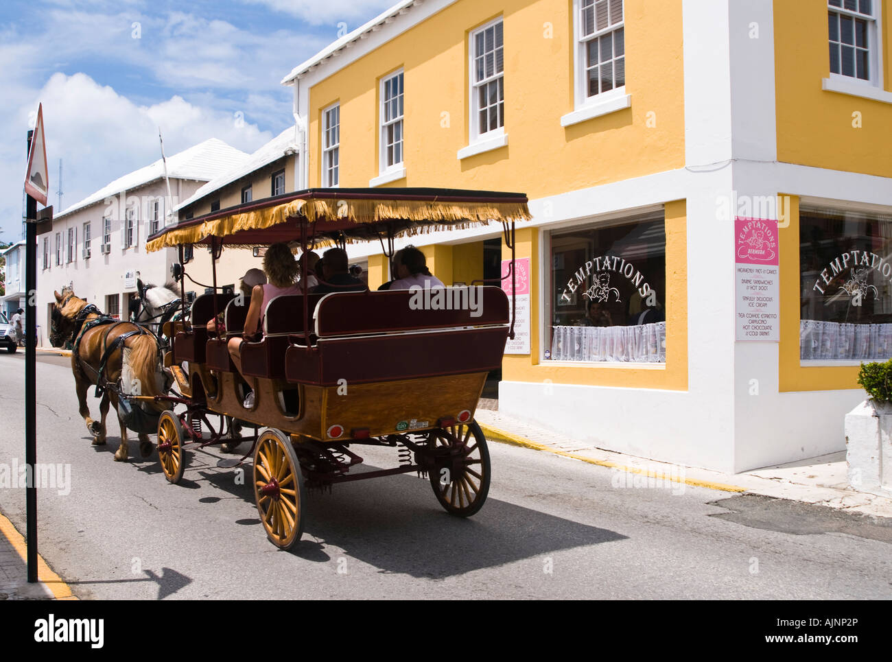 Tourists in horse drawn carriage sightseeing in St George Bermuda Stock Photo