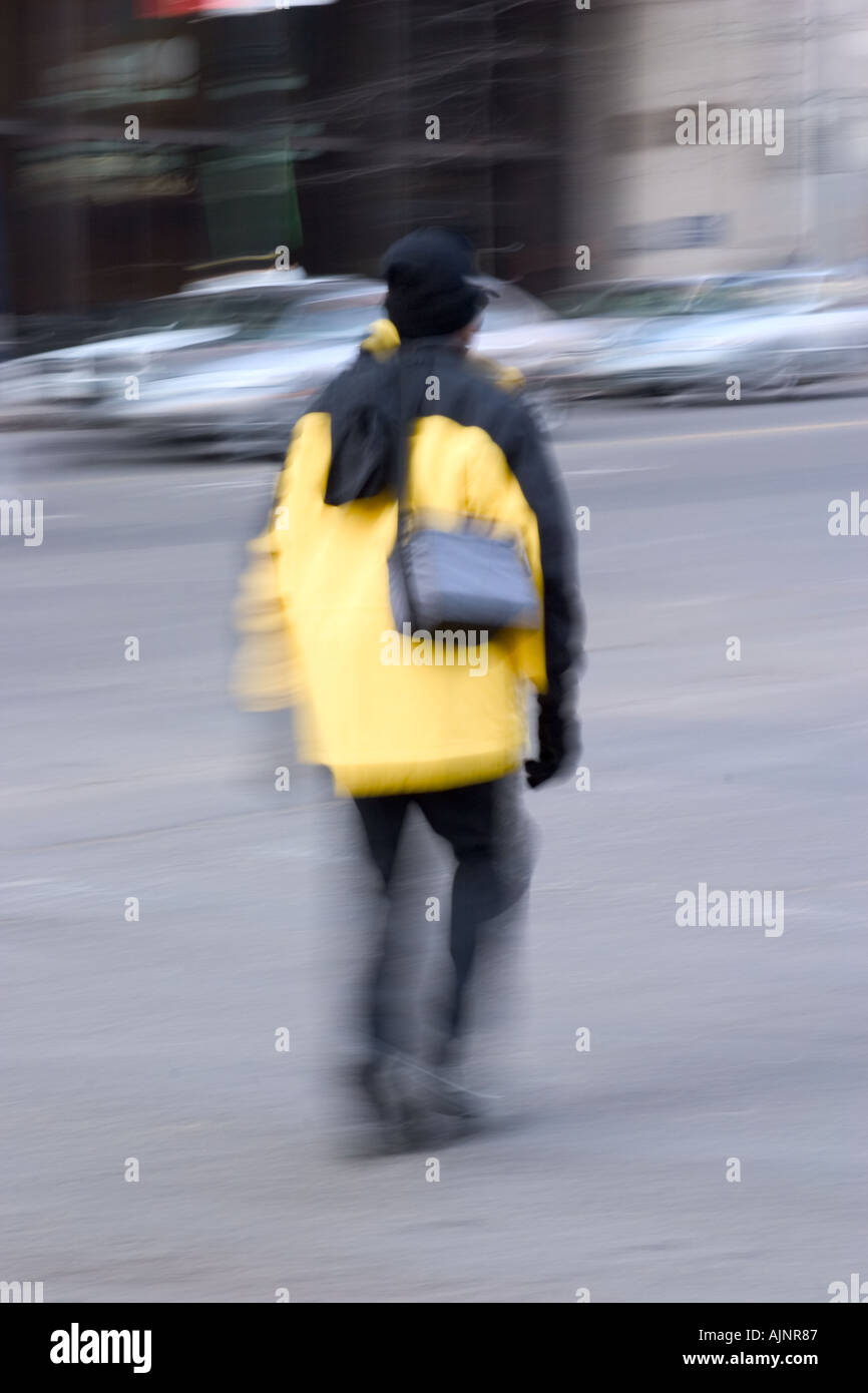 Woman crossing a city street Stock Photo - Alamy