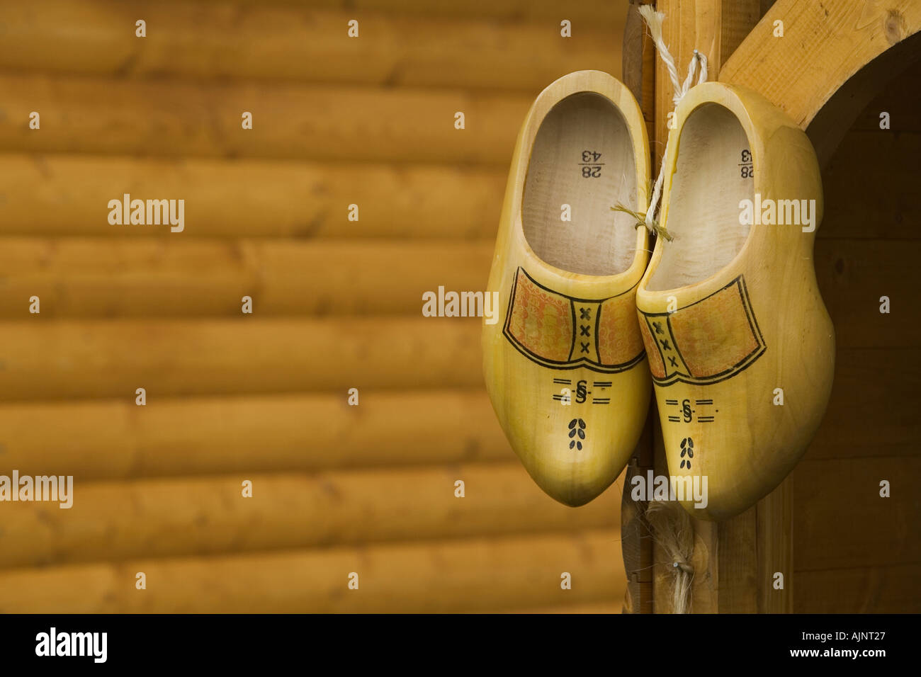 Close up of traditional Dutch wooden shoes hanging on a wall Stock Photo