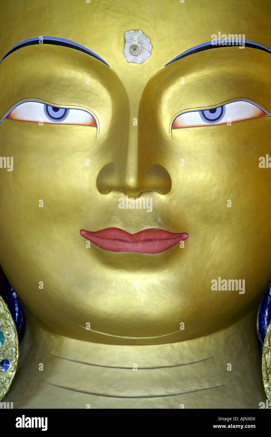 Golden Buddha maitreya compassion face statue front smile TIksey monastery Ladakh India Stock Photo