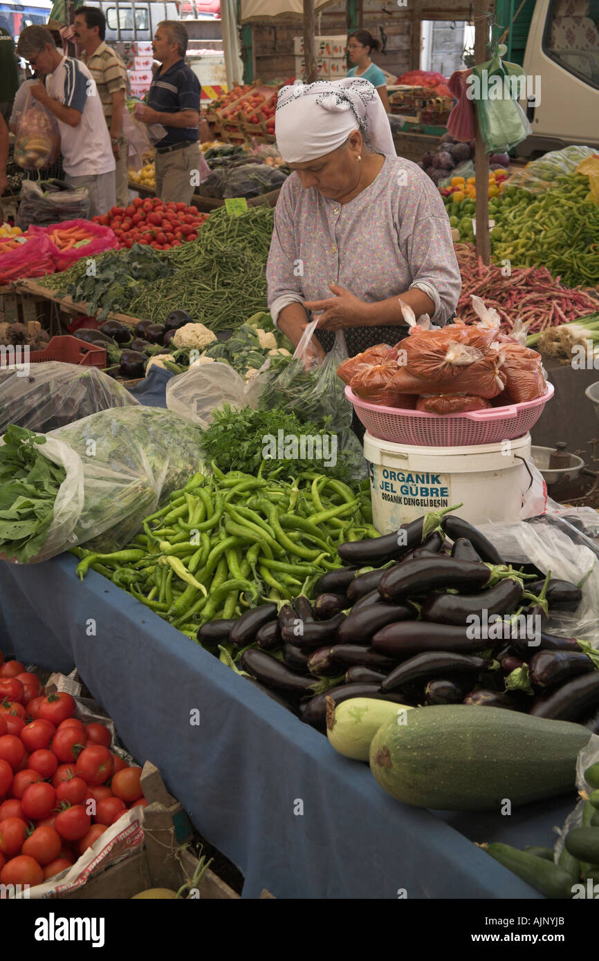 Turkish woman buying vegetable stall in market Kalkan Turkey Stock Photo