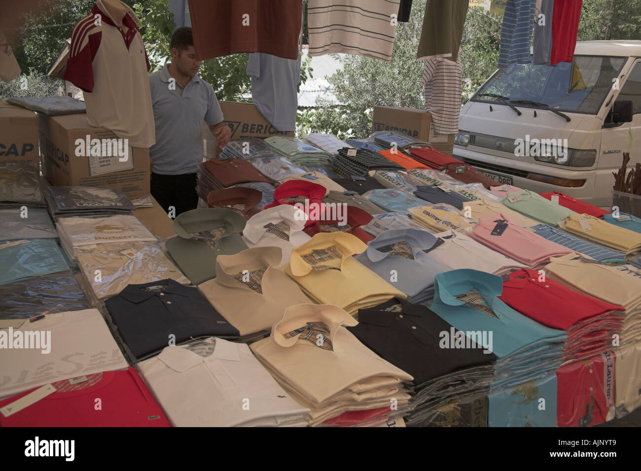 Stock photograph of clothing stall in market Kalkan Turkey selling fake designer label clothing Stock Photo