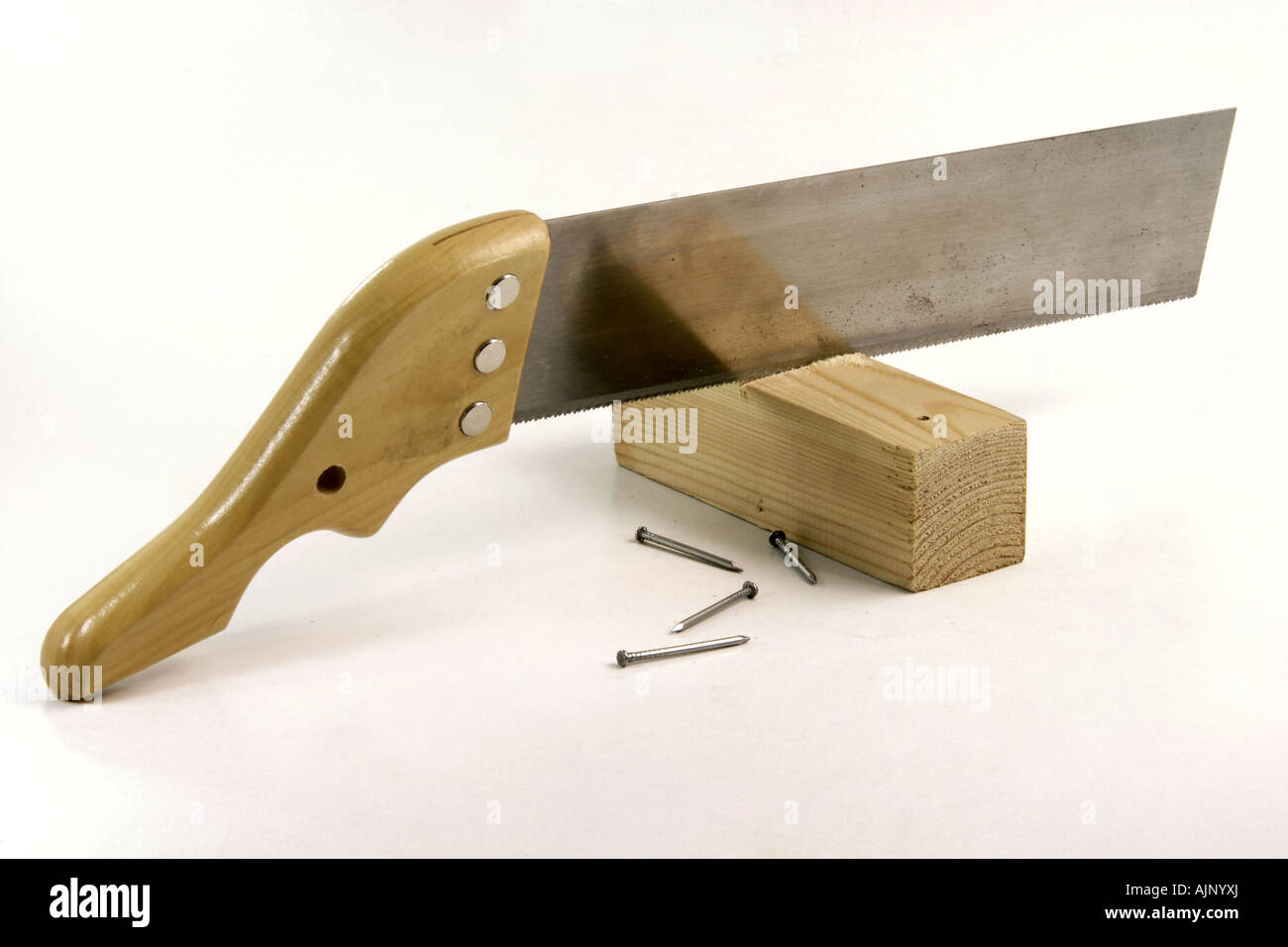 hand saw cutting wood and construction nails in white background