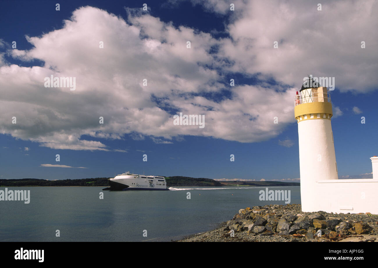 Loch Ryan lighthouse at Cairn Ryan looking across loch to Stranraer to Larne ferry coming into Cairn Ryan Galloway Scotland UK Stock Photo
