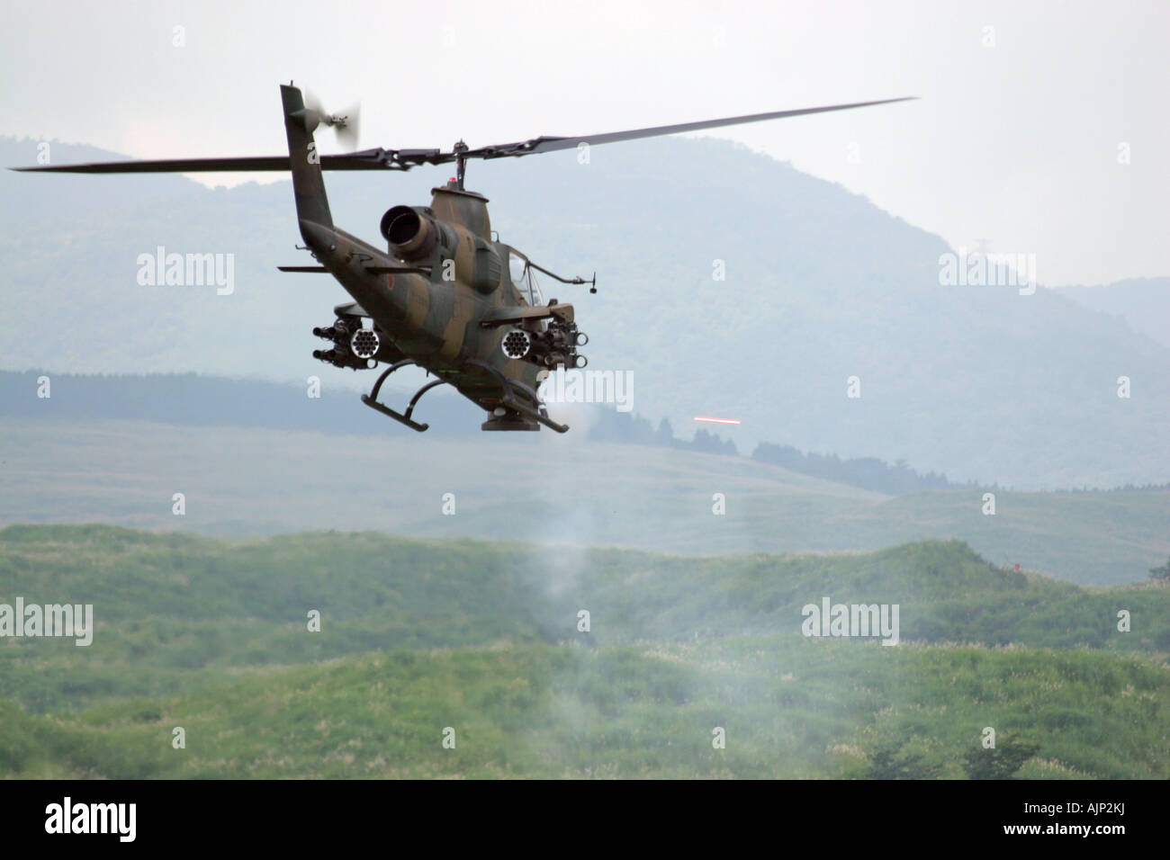 Bell AH-1 Cobra Helicopter of Japan Ground Self Defence Force firing 20mm Machine Gun Stock Photo
