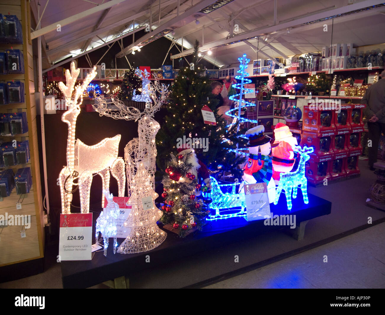 Christmas decorations on display in UK garden centre Stock Photo
