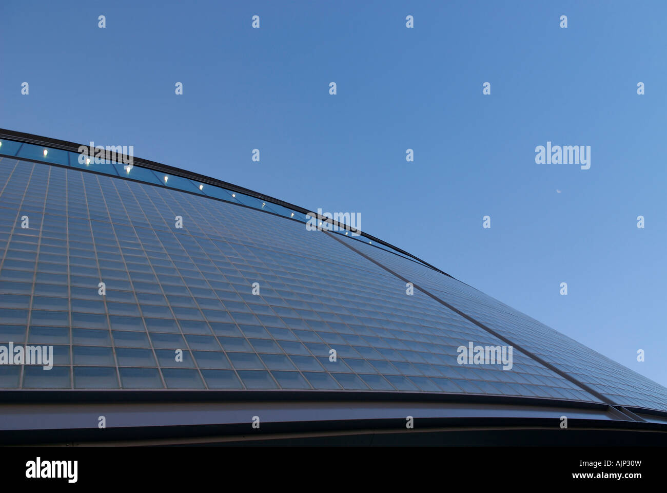 Upward Shot of curved building with clear crisp sky. Modern architecural finsh. Stock Photo