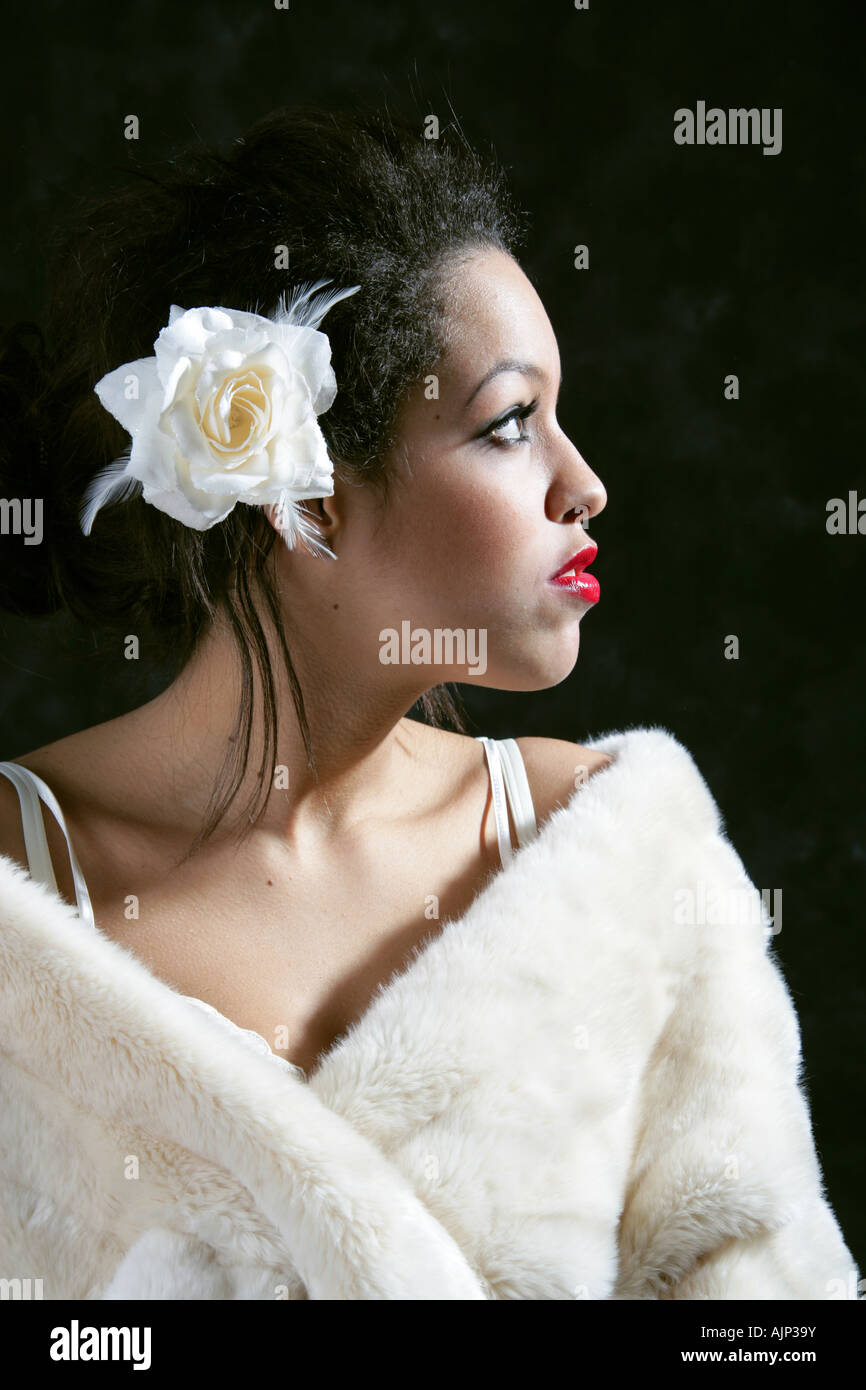 Girl in a White Fur Stole with a Flower in Her Hair Stock Photo