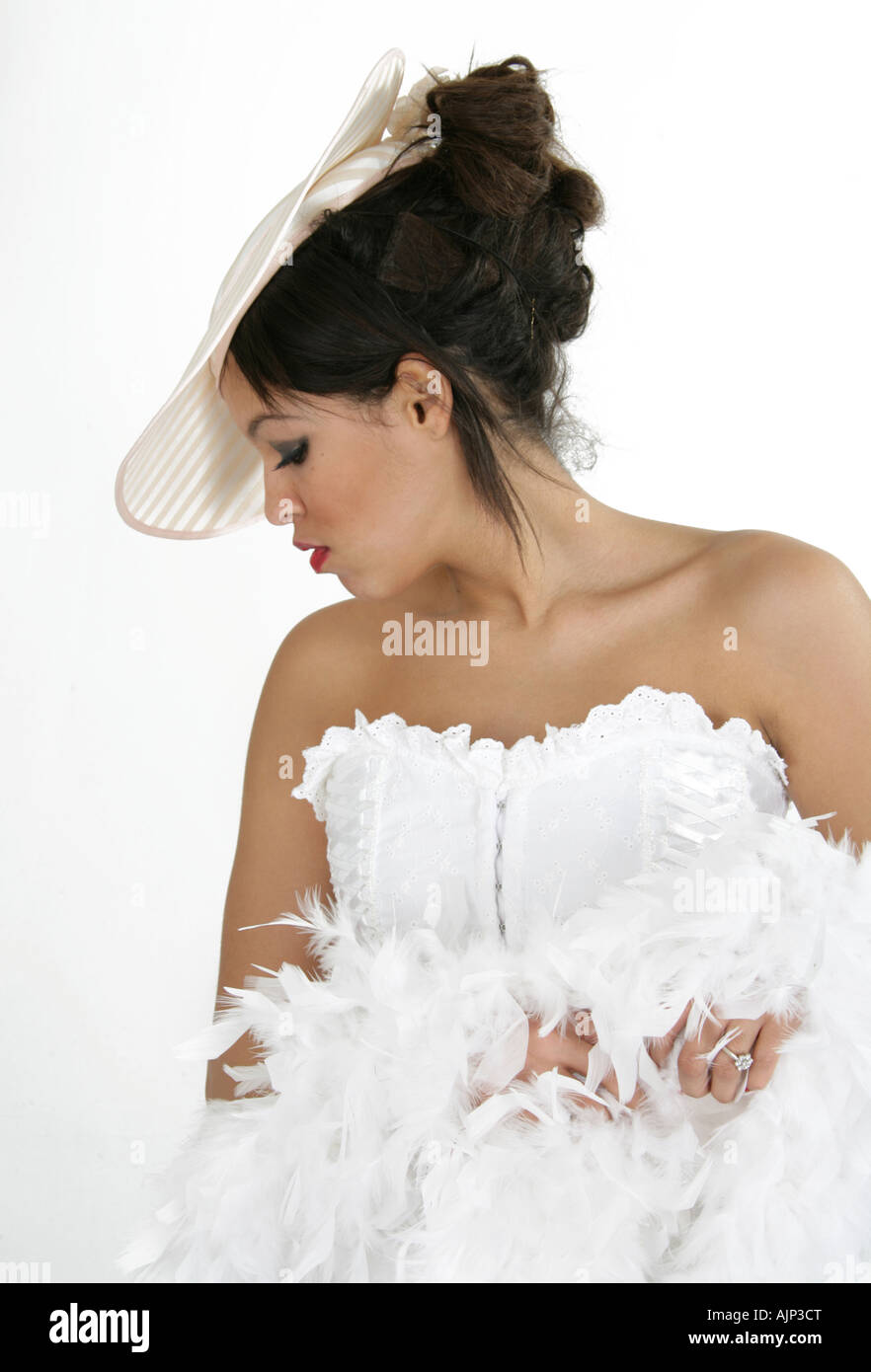 Girl in a White Corset and Hat with Feather Boa Stock Photo