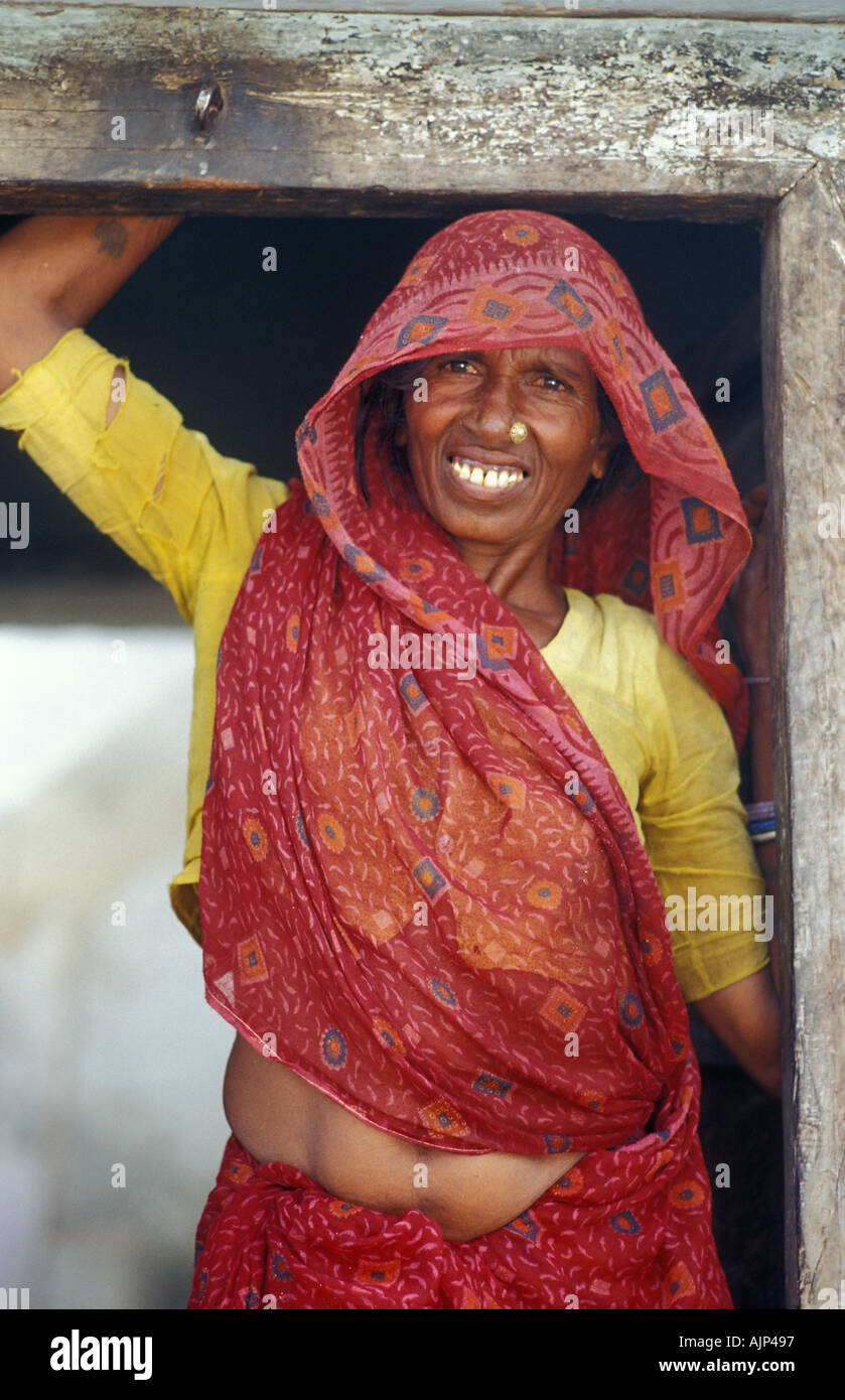 Friendly rural woman from Madhya Pradesh near Khajuraho standing at the  door to her home Stock Photo - Alamy