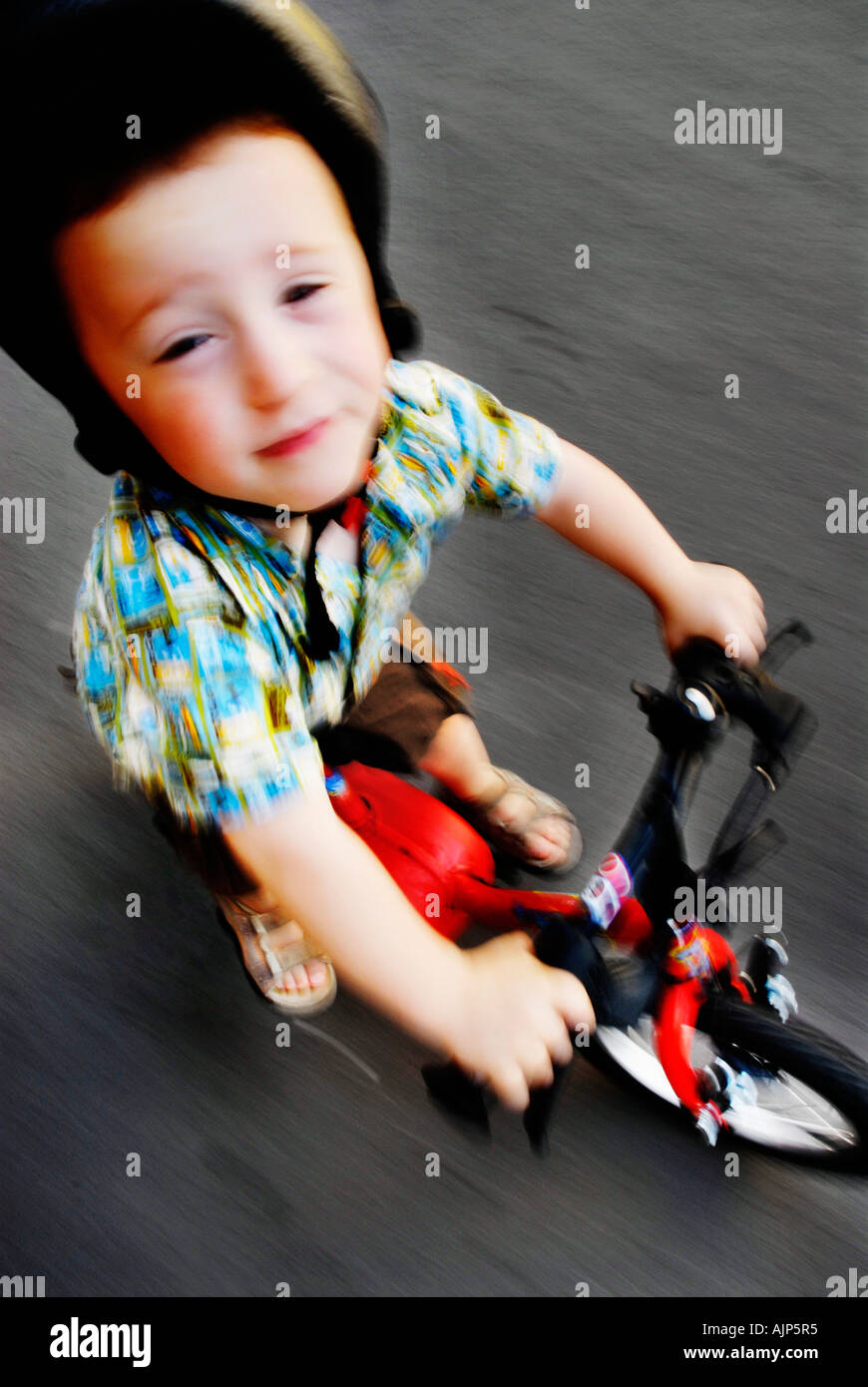Boy Riding Bike Training Wheels High Resolution Stock Photography and