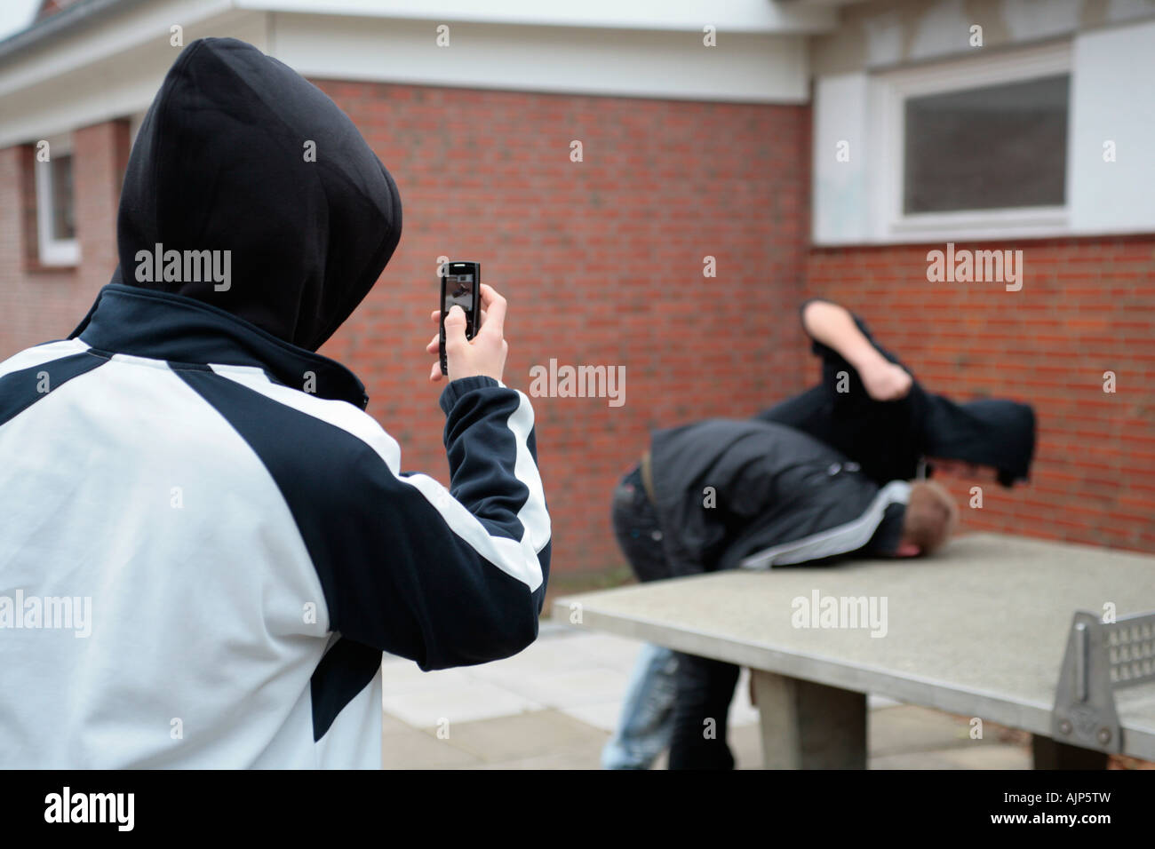 two fighting boys are being recorded by mobile phone Stock Photo