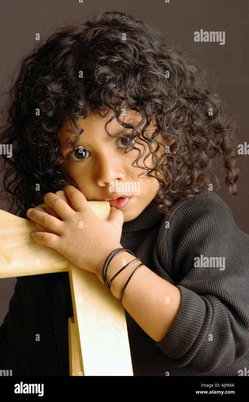 Portrait of a cute girl with curly hair Stock Photo - Alamy