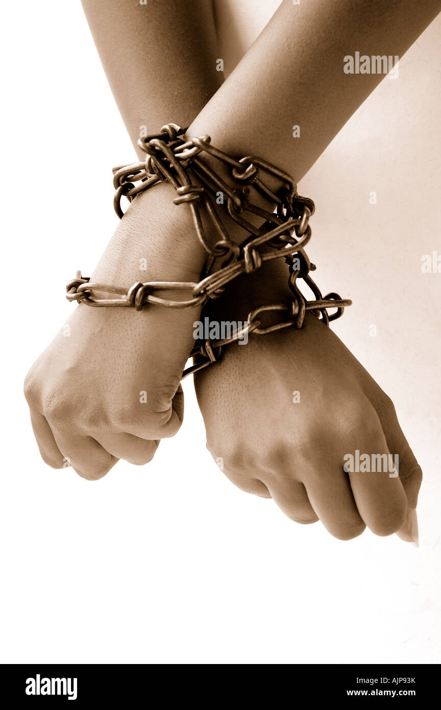 Hands chained at the wrists Stock Photo