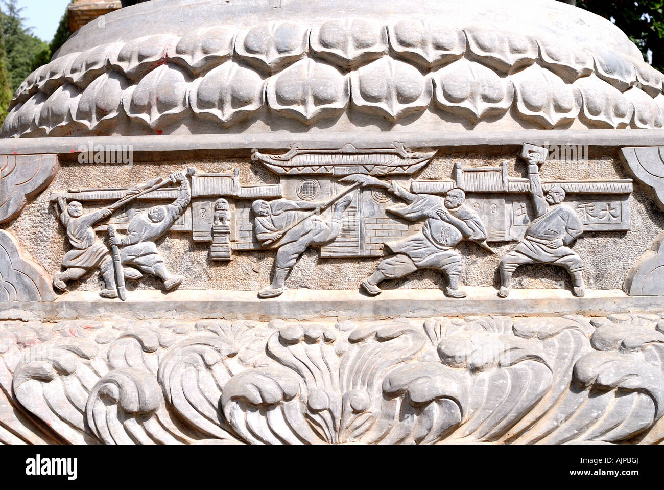 Bas relief of martial arts on pagoda at pagoda forest stupa at Shaolin Buddhist Monastery Temple Henan Province Luoyang Dengfeng Stock Photo