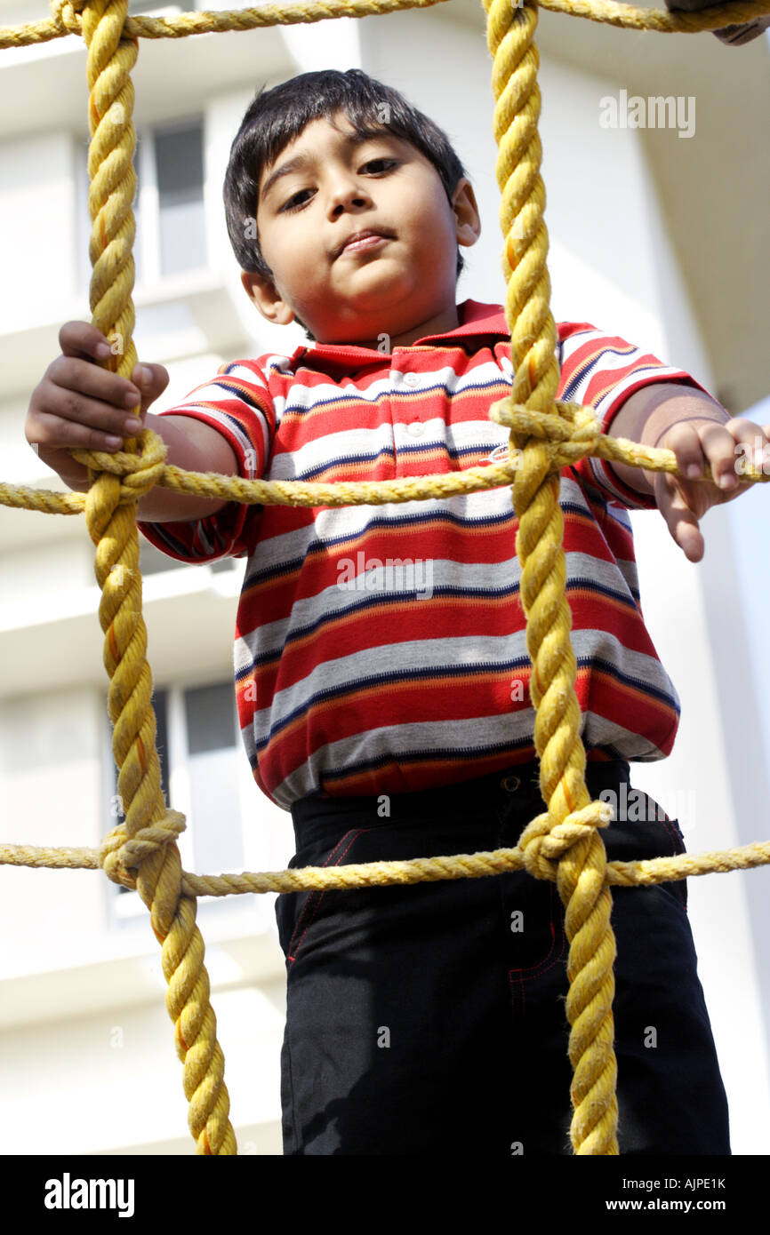 Boy Using A Rope Boy playing outdoor climbing rope hi-res stock photography and images ...