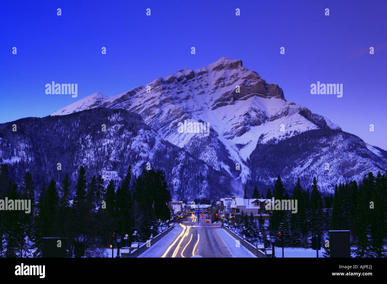 Cascade Mountain and Banff Avenue in winter at dusk Town of Banff Banff National Park Alberta Canada Stock Photo