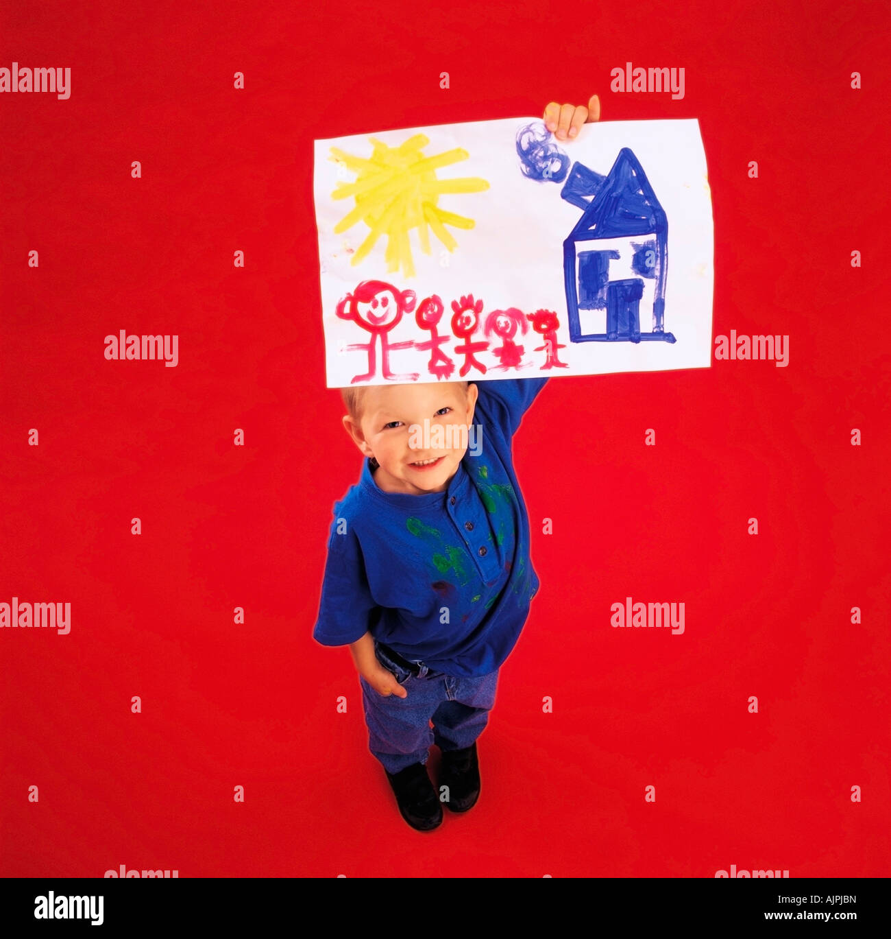 High angle view of a boy showing his painting at camera Stock Photo - Alamy