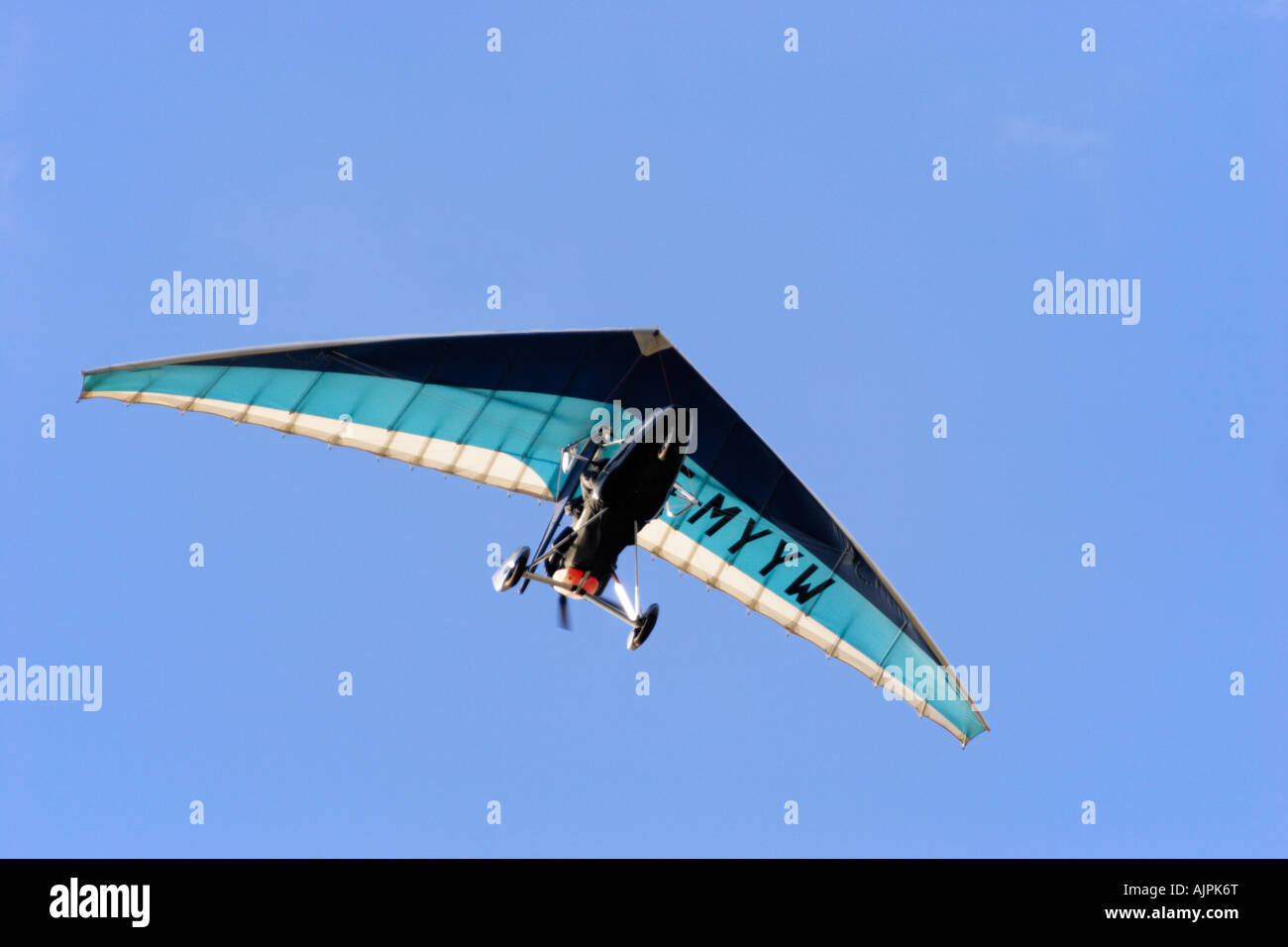 Horizontal photo of a Microlite flying against a blue sky Stock Photo