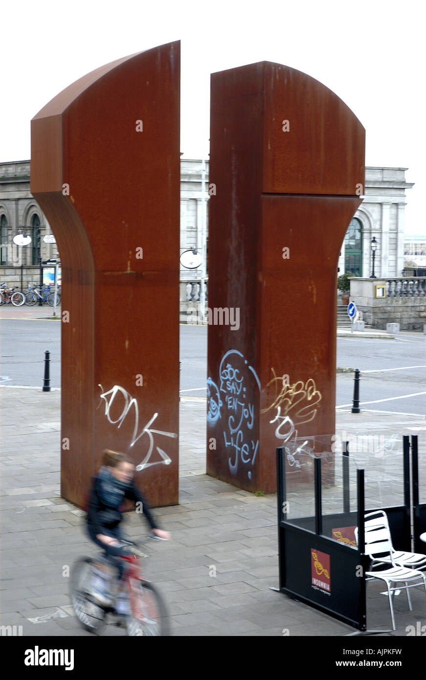 Young girl on bicycle, grafitti on sculpture, Dun Laoghaire, Ireland