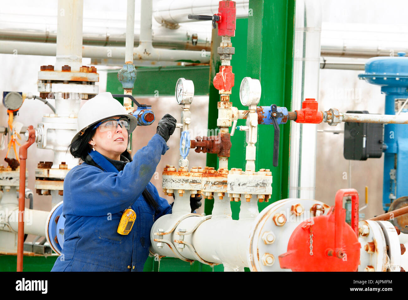 Woman working on a boiler system Stock Photo