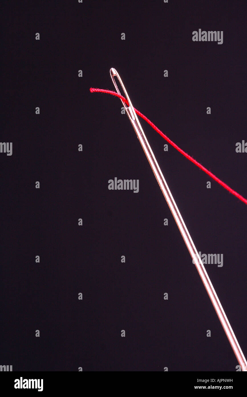 A thread passing through a needle Stock Photo Alamy