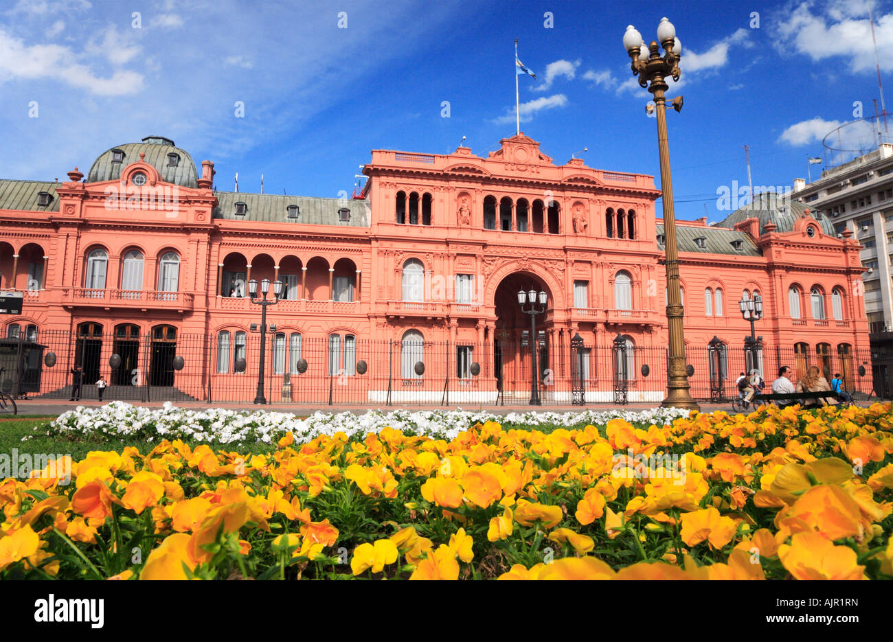 “Pink House” (National Government presidential Palace) with people and flowers from Plaza de Mayo, Buenos Aires, Argentina Stock Photo
