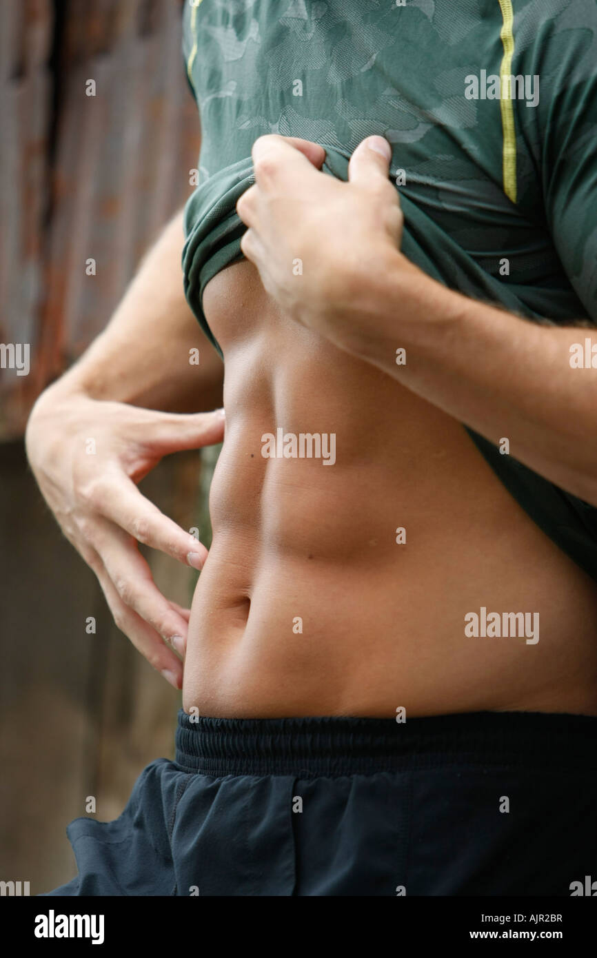 fit muscular hard body male model with great abs posing Stock Photo - Alamy