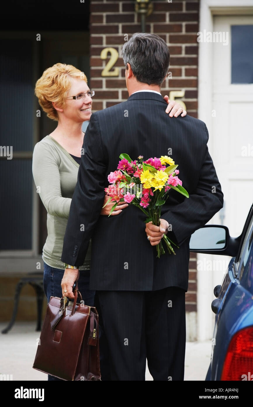 Husband holding flowers for his wife Stock Photo Alamy