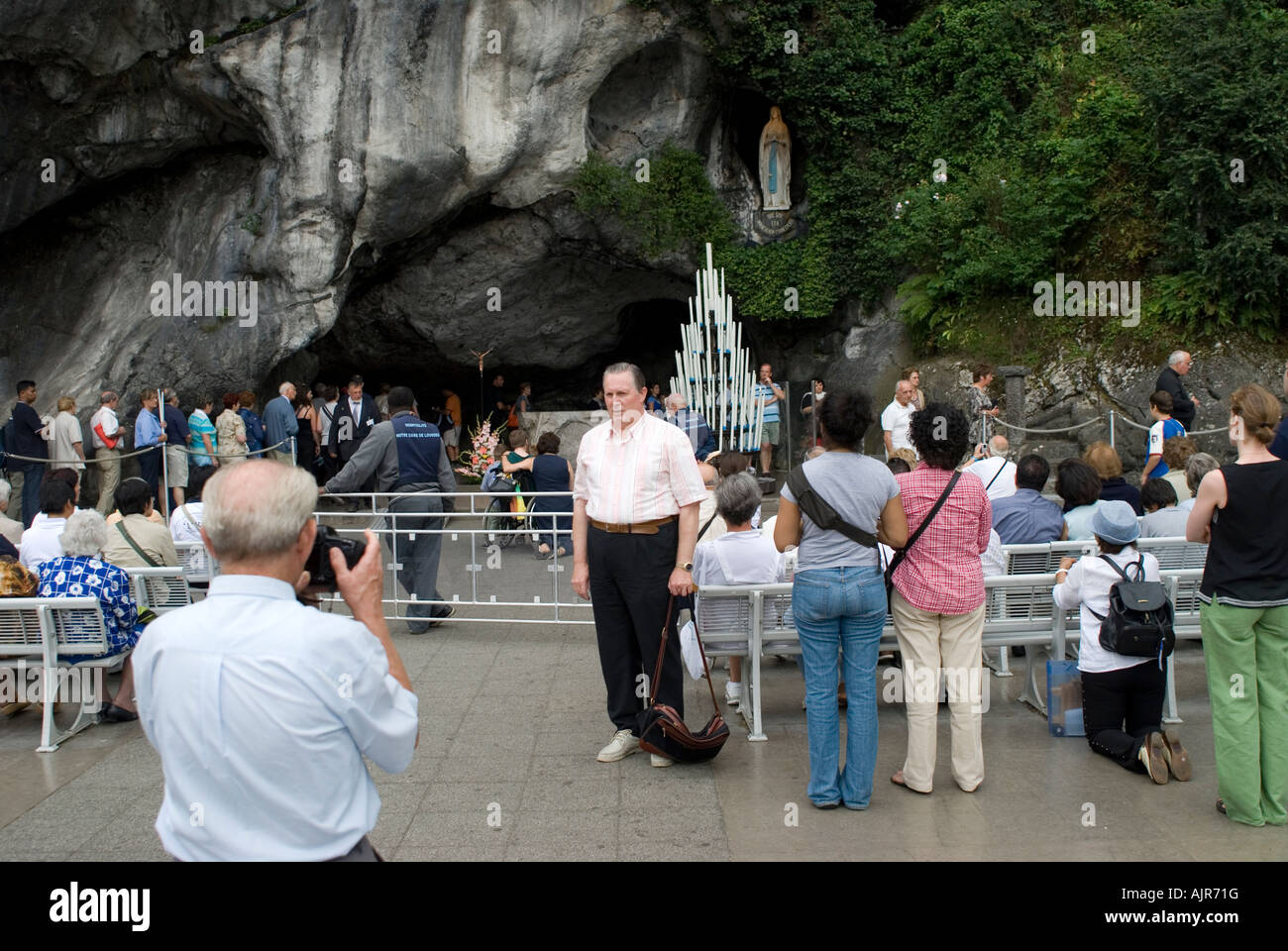 Pilgrims in front of grotto taking pictures of each other Stock Photo