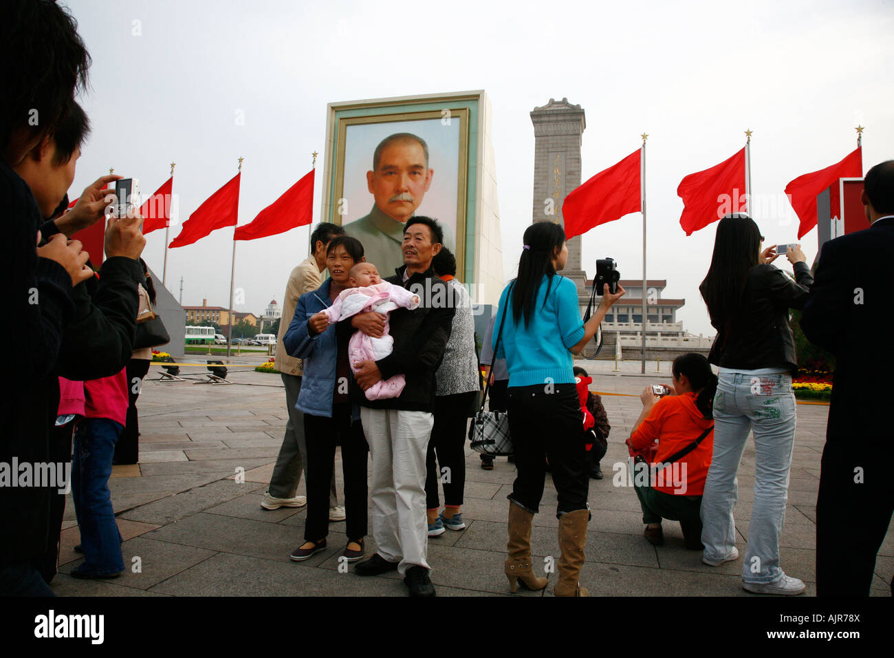 People at Tiananmen Square with the monument to the peoples heros Beijing China Stock Photo