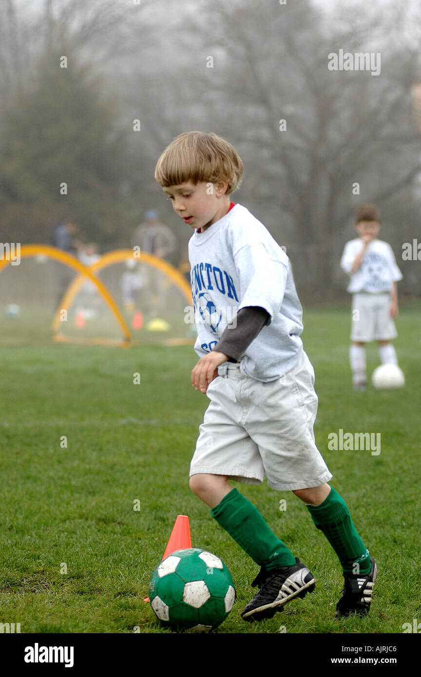 Boy playing soccer football Stock Photo