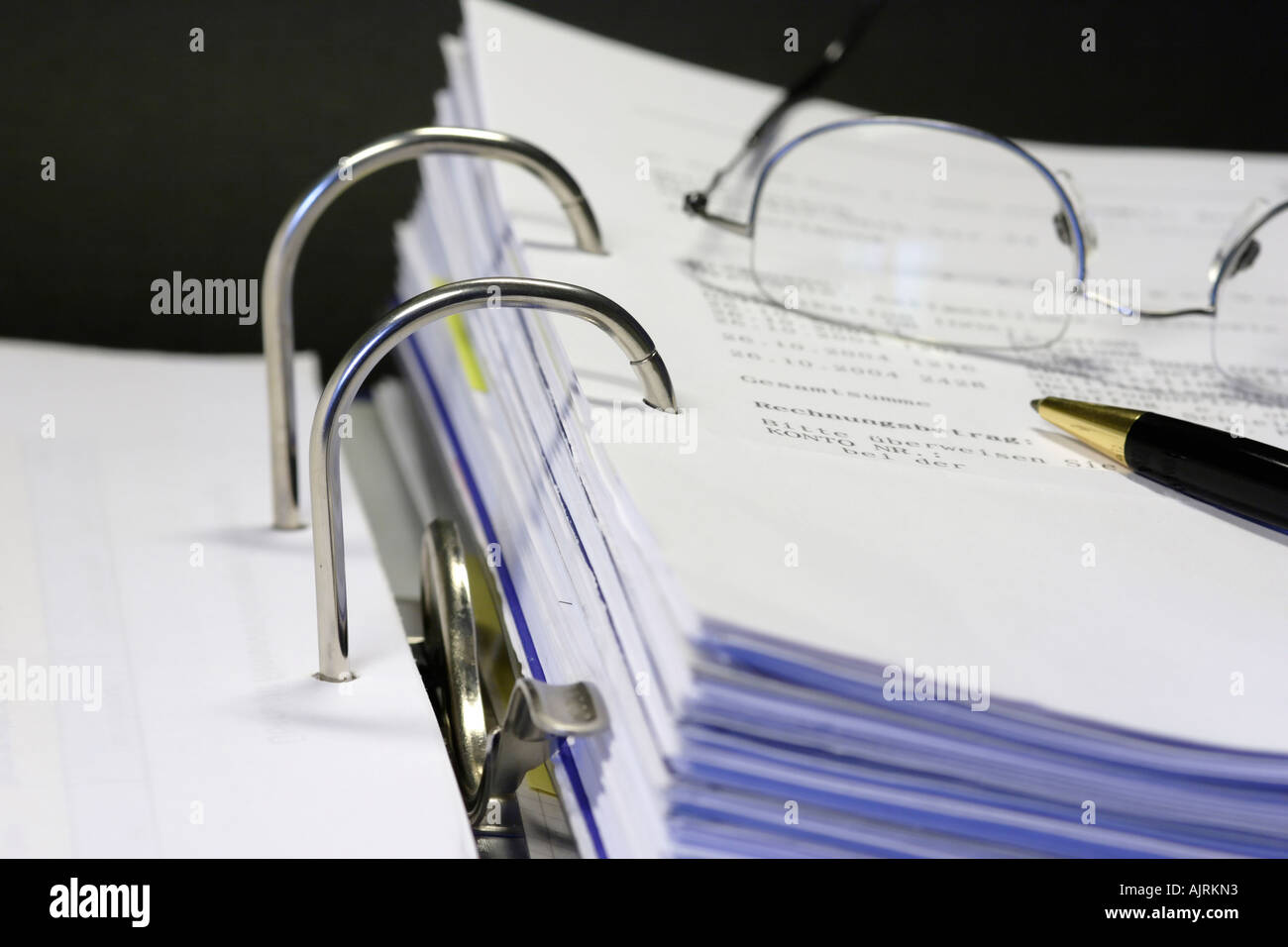 Open binder with different documents on black background Stock Photo