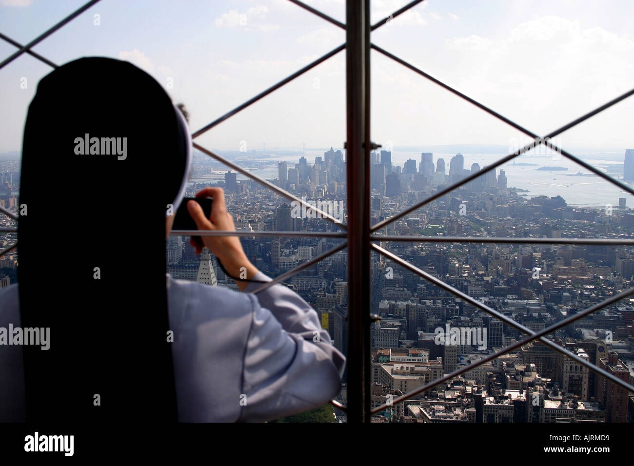 A Nun taking a picture from the top of The Empire State Building New York United States of America Stock Photo