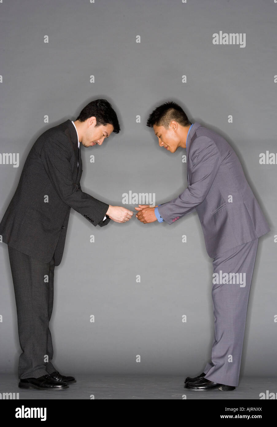 Side profile of two businessmen greeting each other Stock Photo - Alamy