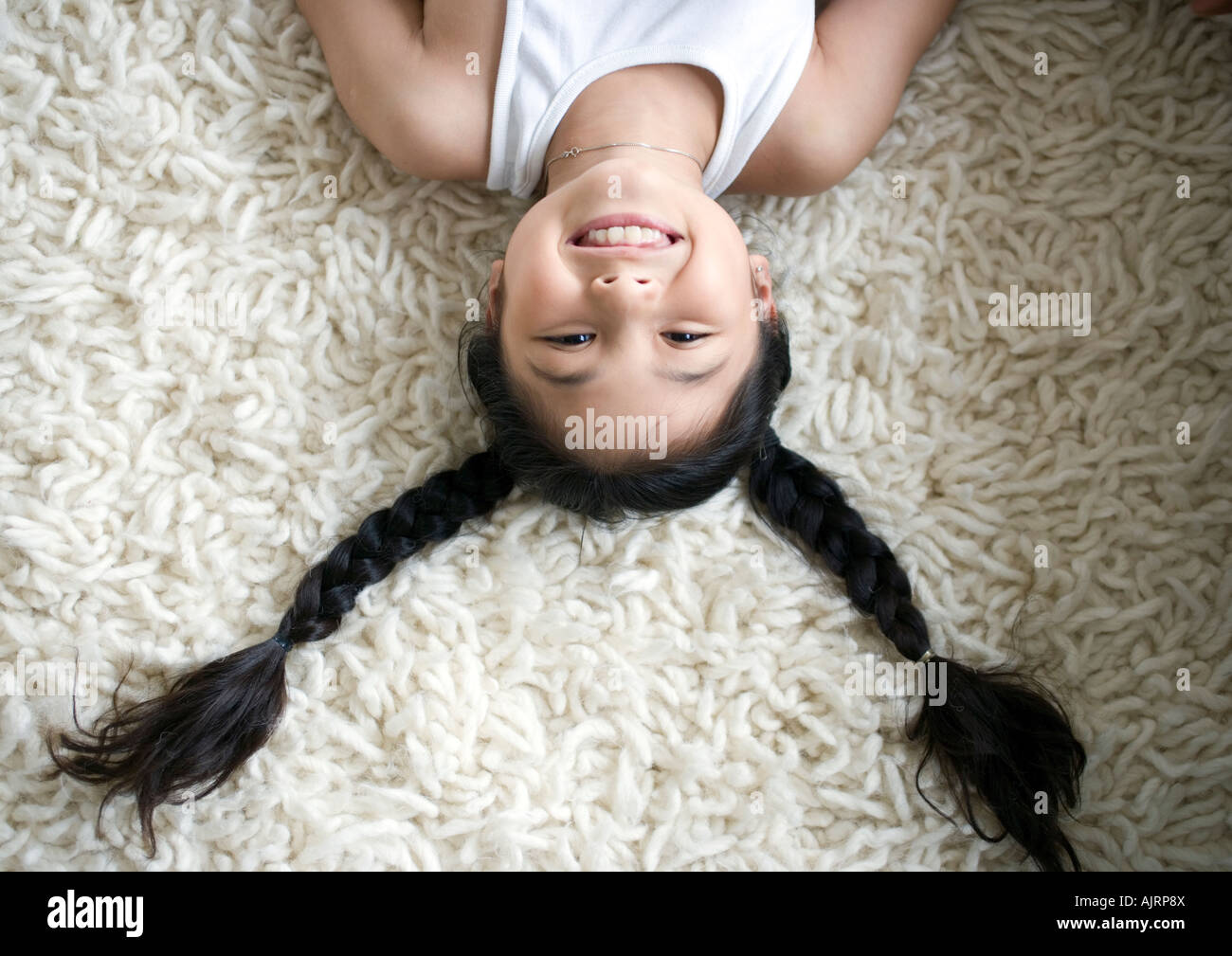 High angle view of a girl lying on her back Stock Photo
