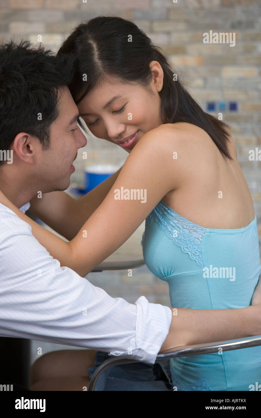 Side profile of a young man embracing a young woman Stock Photo - Alamy