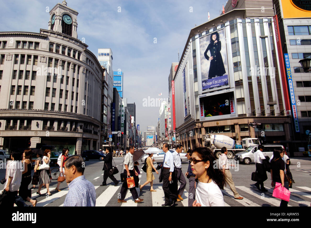 Pedestrians cross street in upmarket shopping district of Ginza in Tokyo Japan Stock Photo