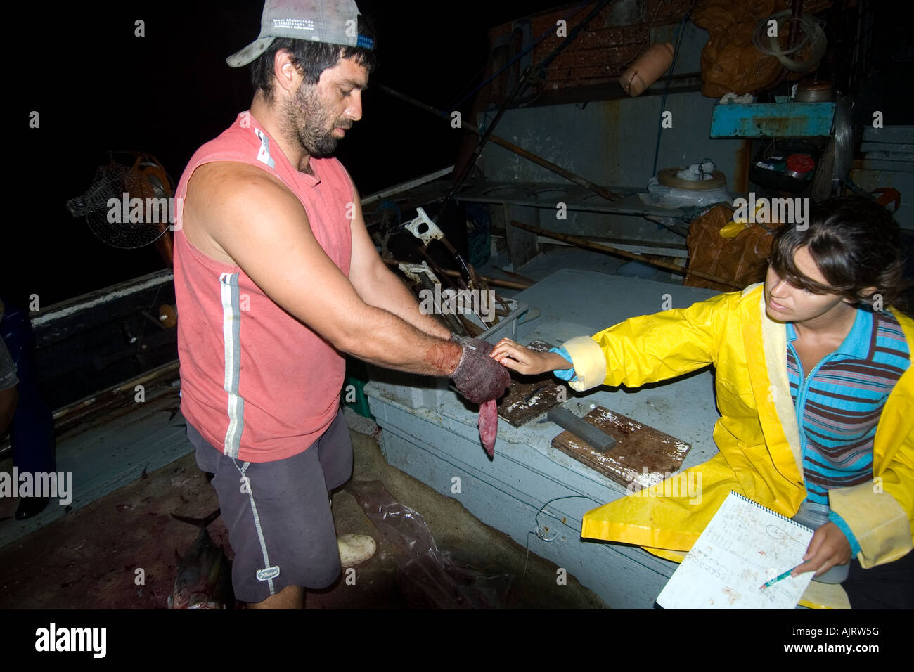 Graduate student places tag inside tuna stomach handed by fisherman St Peter and St Paul s rocks