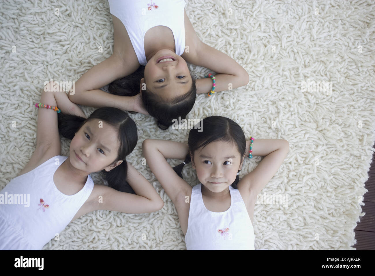 Portrait of three girls lying down Stock Photo