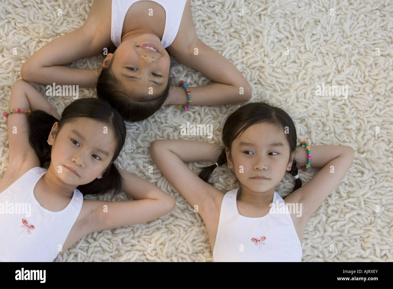 Portrait of three girls lying down Stock Photo