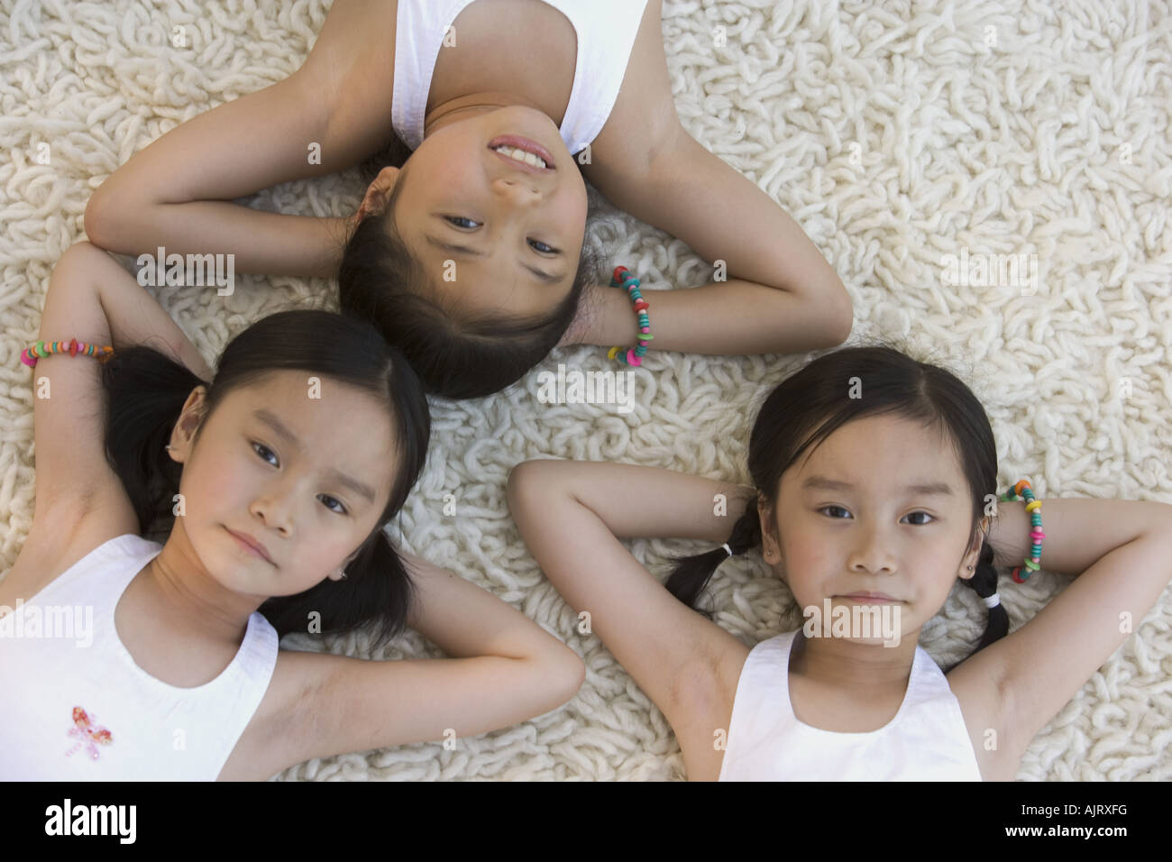 Portrait of three girls lying down Stock Photo