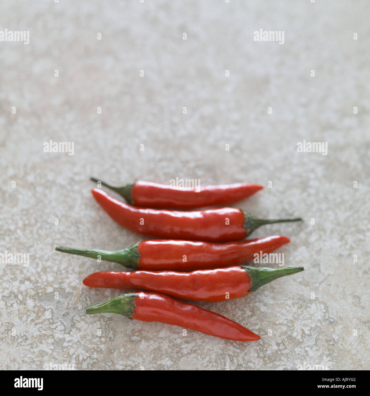 Red chillies on marble surface Stock Photo