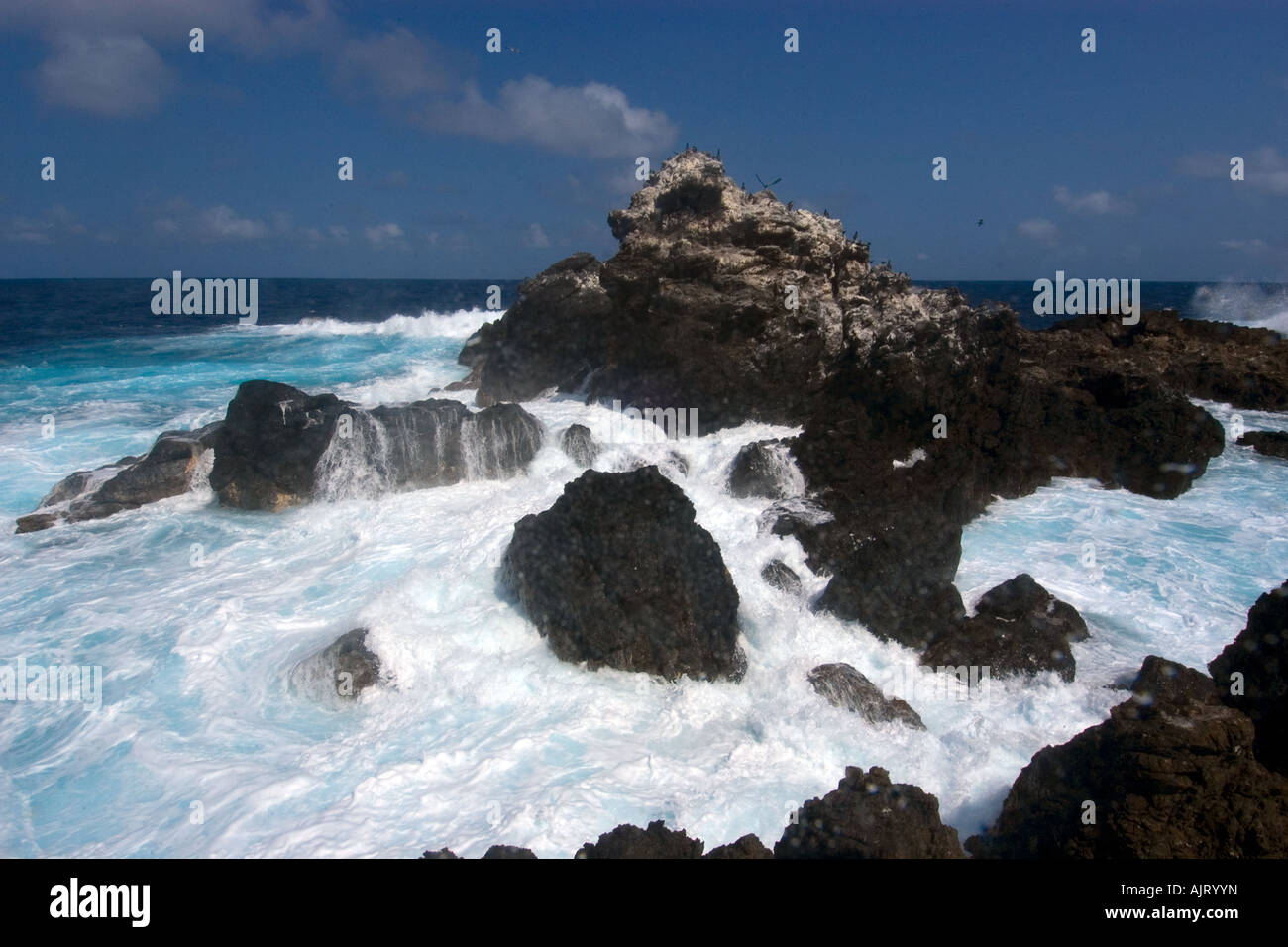 Wave crashing over rocks St Peter and St Paul s rocks Brazil Atlantic Ocean Stock Photo
