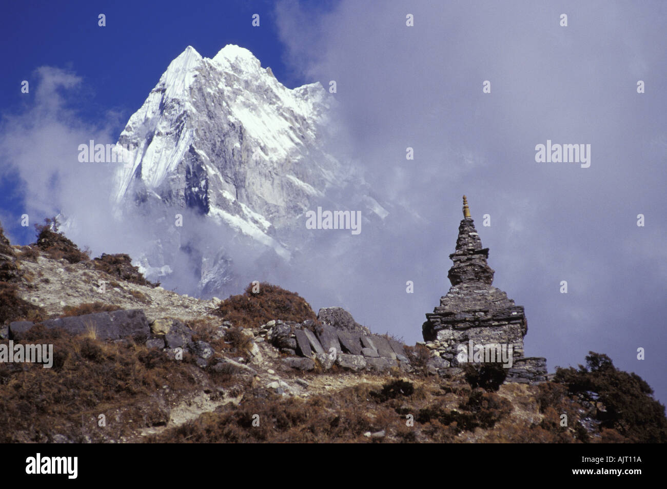 Snow covered peak with cultural monument in forefront Stock Photo