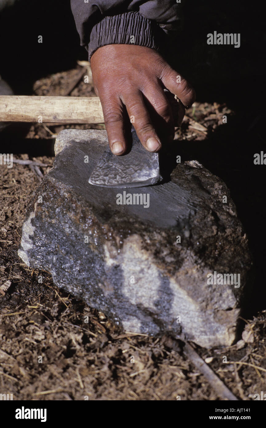 Sharpening an axe on a stone Stock Photo Alamy