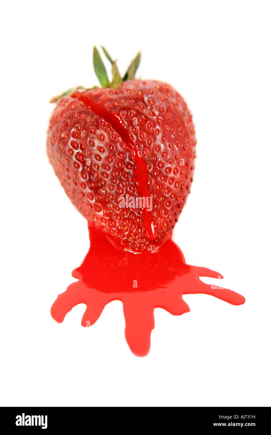 Large red ripe strawberry dripping juice on white background Stock