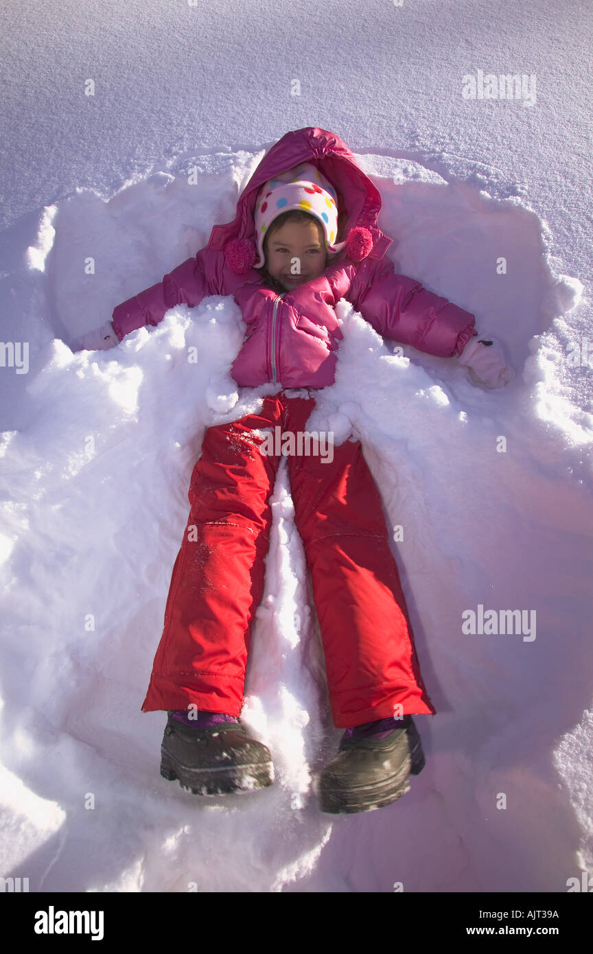 Girl making a snow angel Stock Photo Alamy