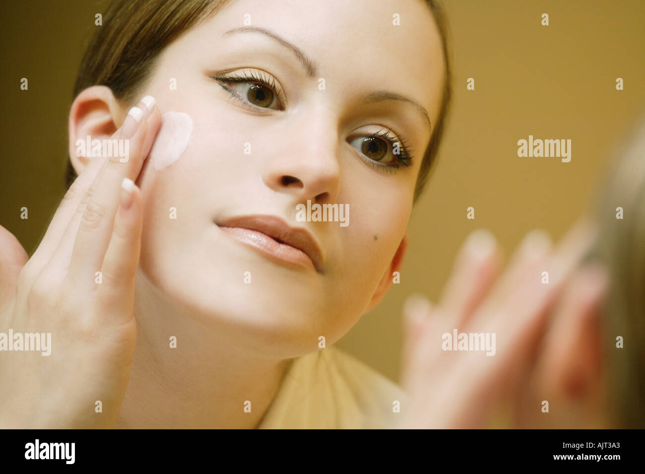 Woman applying make up Stock Photo